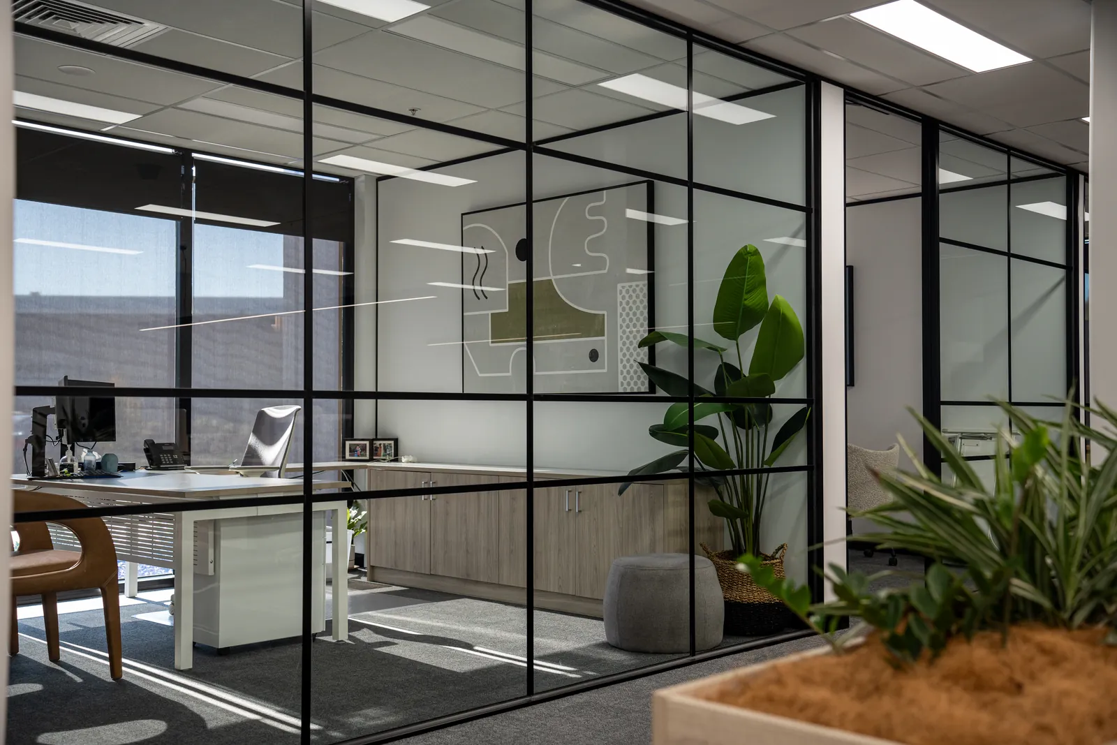 Glazed offices along the workplace edge, with planting in the foreground