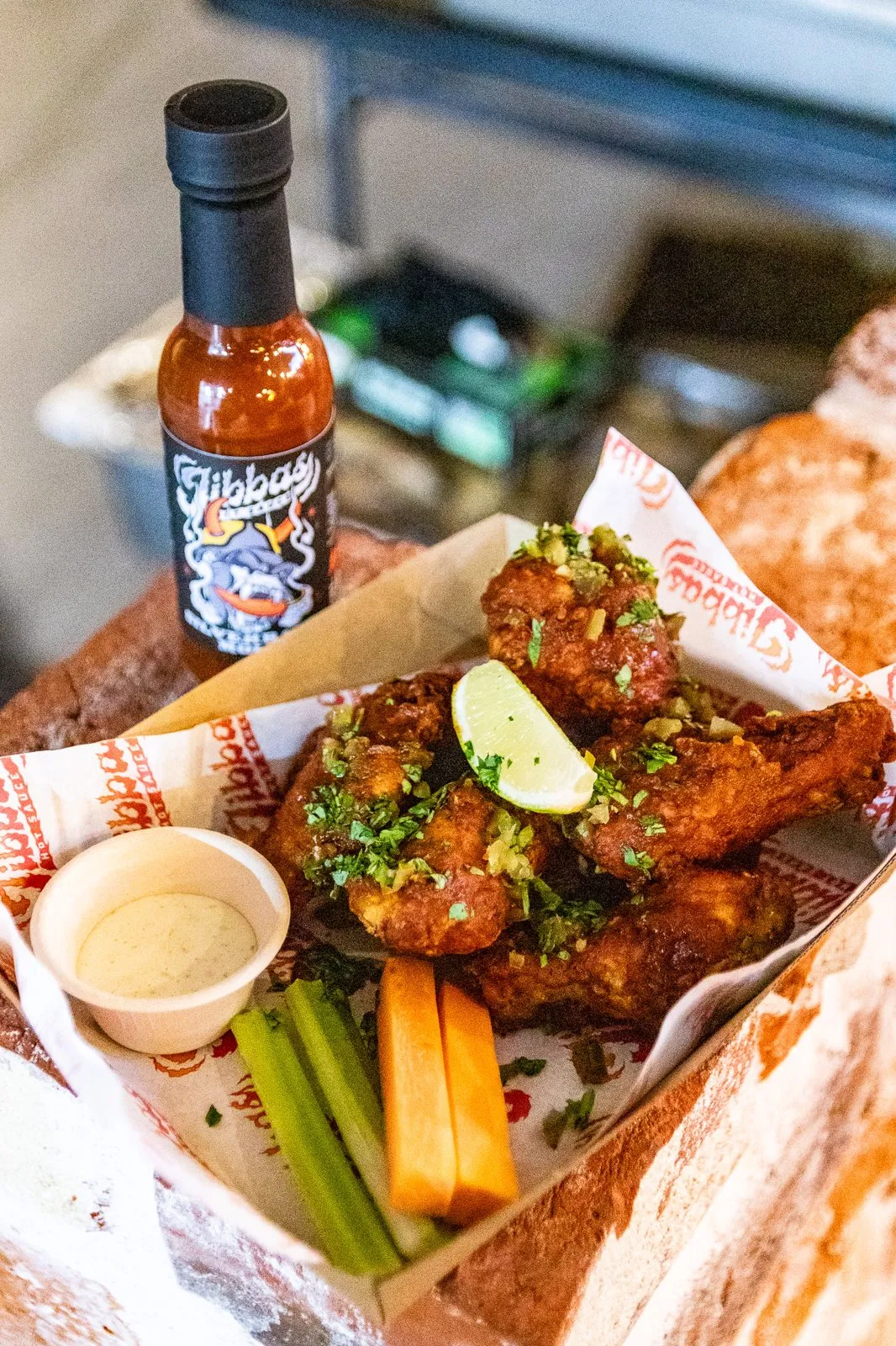 Jibba's Hot Sauce with chicken wings, lime and dipping sauce