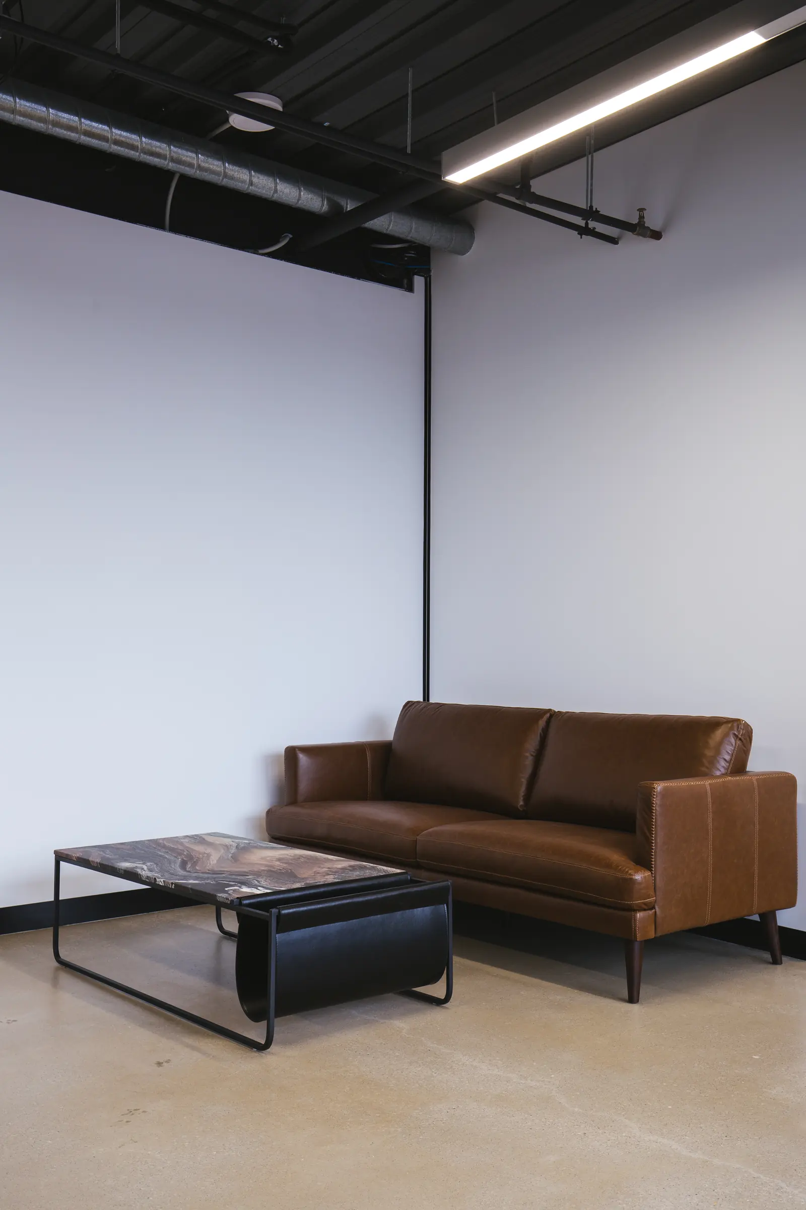Leather sofa and stone-topped coffee table in the waiting area